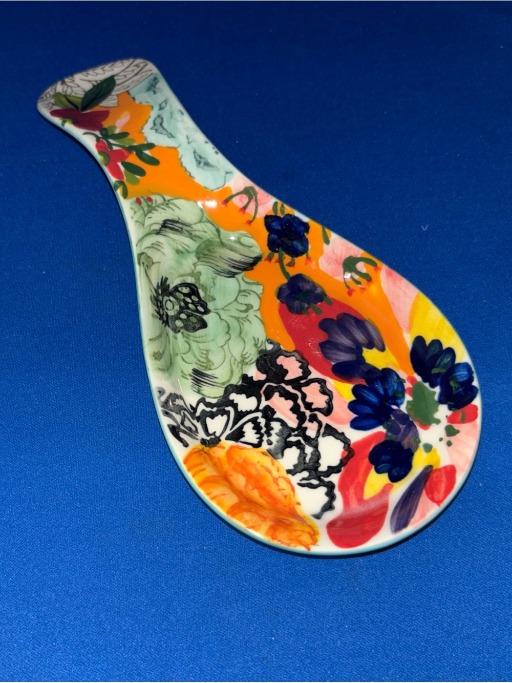 Anthropologie Amaryllis hand-painted ceramic spoon rest with floral design.